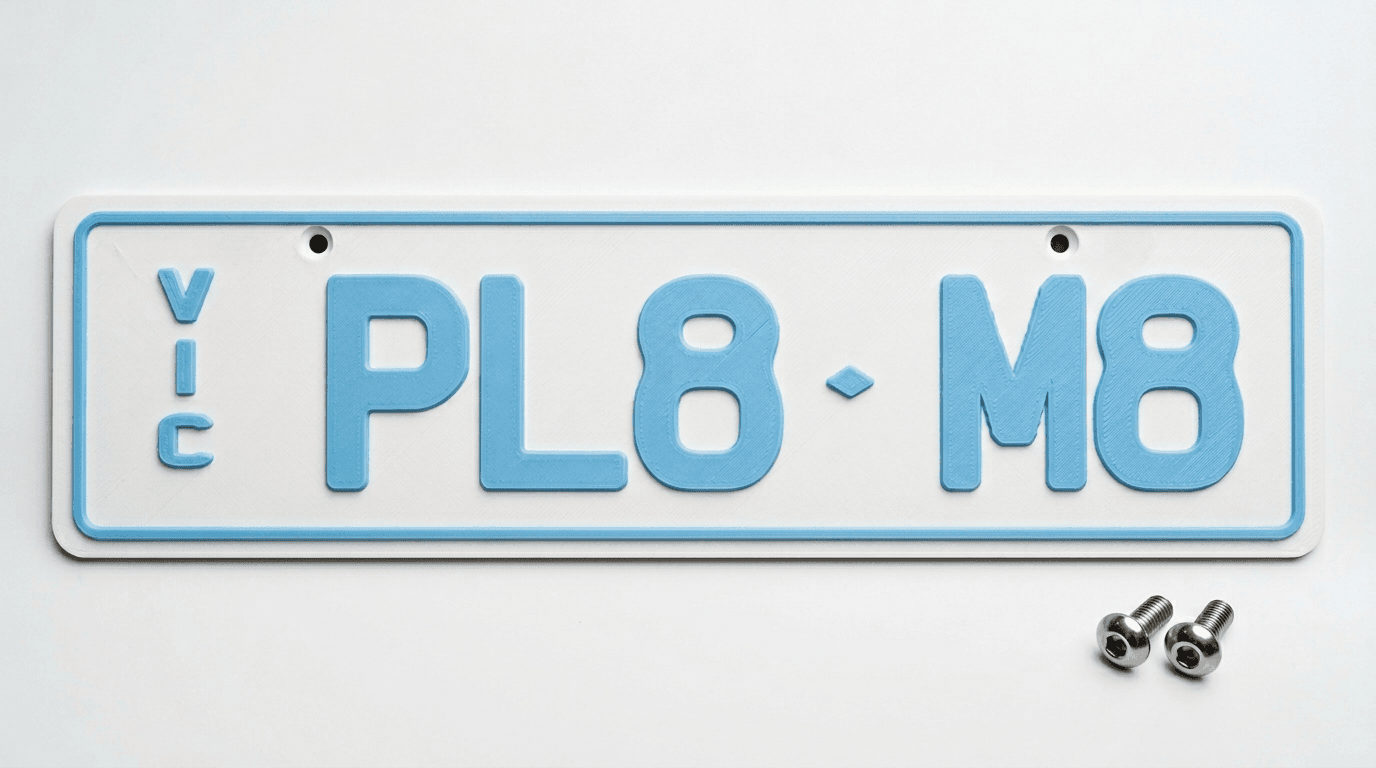 Front of a 3D-printed VIC slimline plate with screw holes at the top corners and stainless steel screws alongside